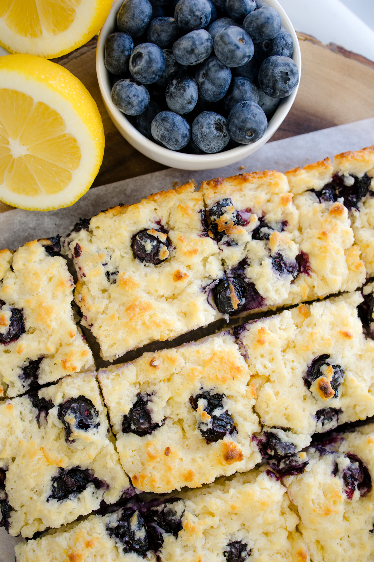 Overhead view of Blueberry Biscuits next to blueberries and lemons.