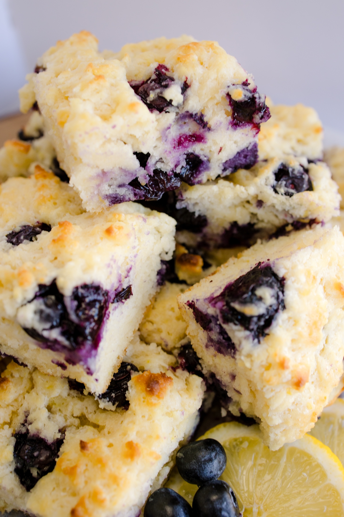 Angled view of Blueberry Biscuits stacked on top of each other.