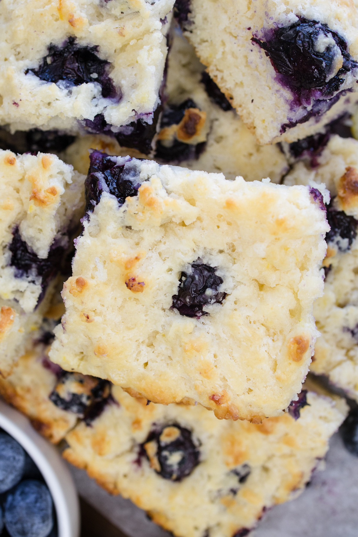Close overhead view of Blueberry Biscuits stacked on top of each other.