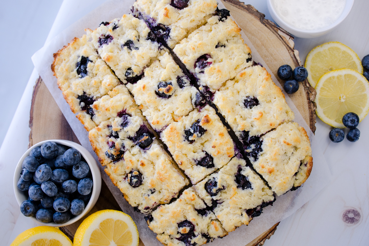 Overhead view of Blueberry Biscuits next to blueberries and sliced lemons.