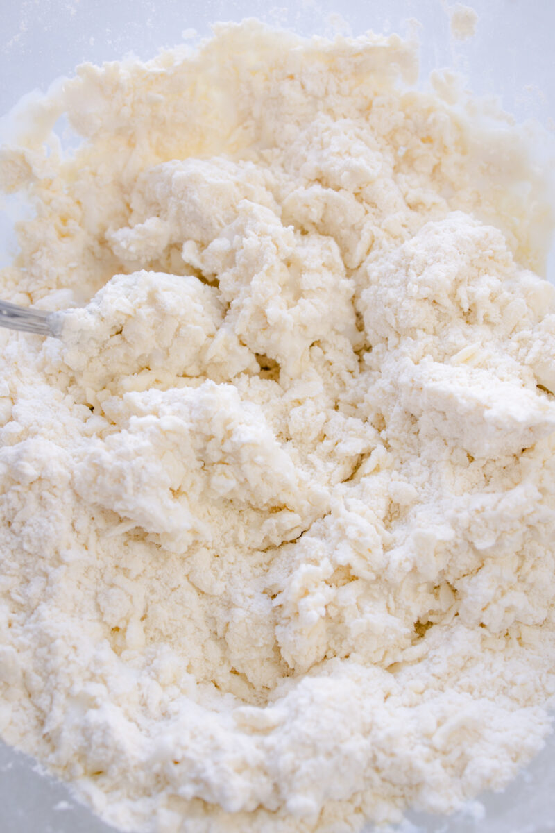 Overhead view of biscuit dough being mixed together.