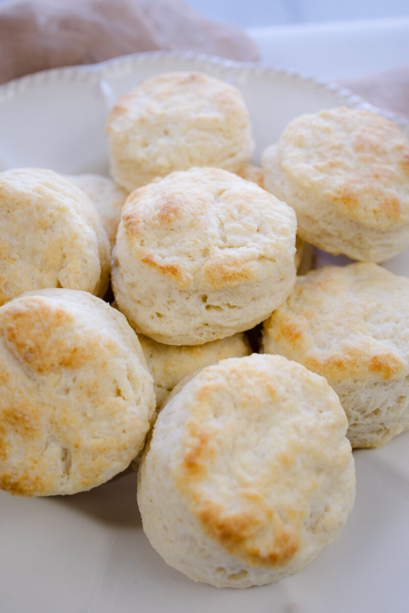 Angled view of Buttermilk Biscuits on a white serving platter.