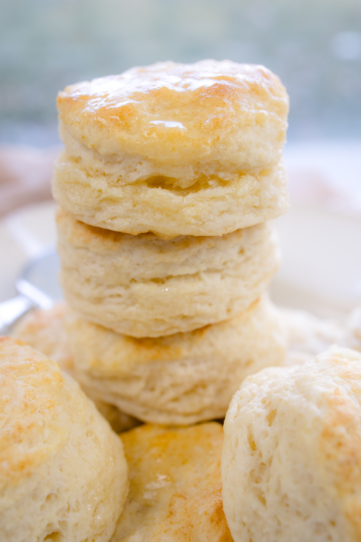 Close view of buttermilk biscuits stacked on top of each other.