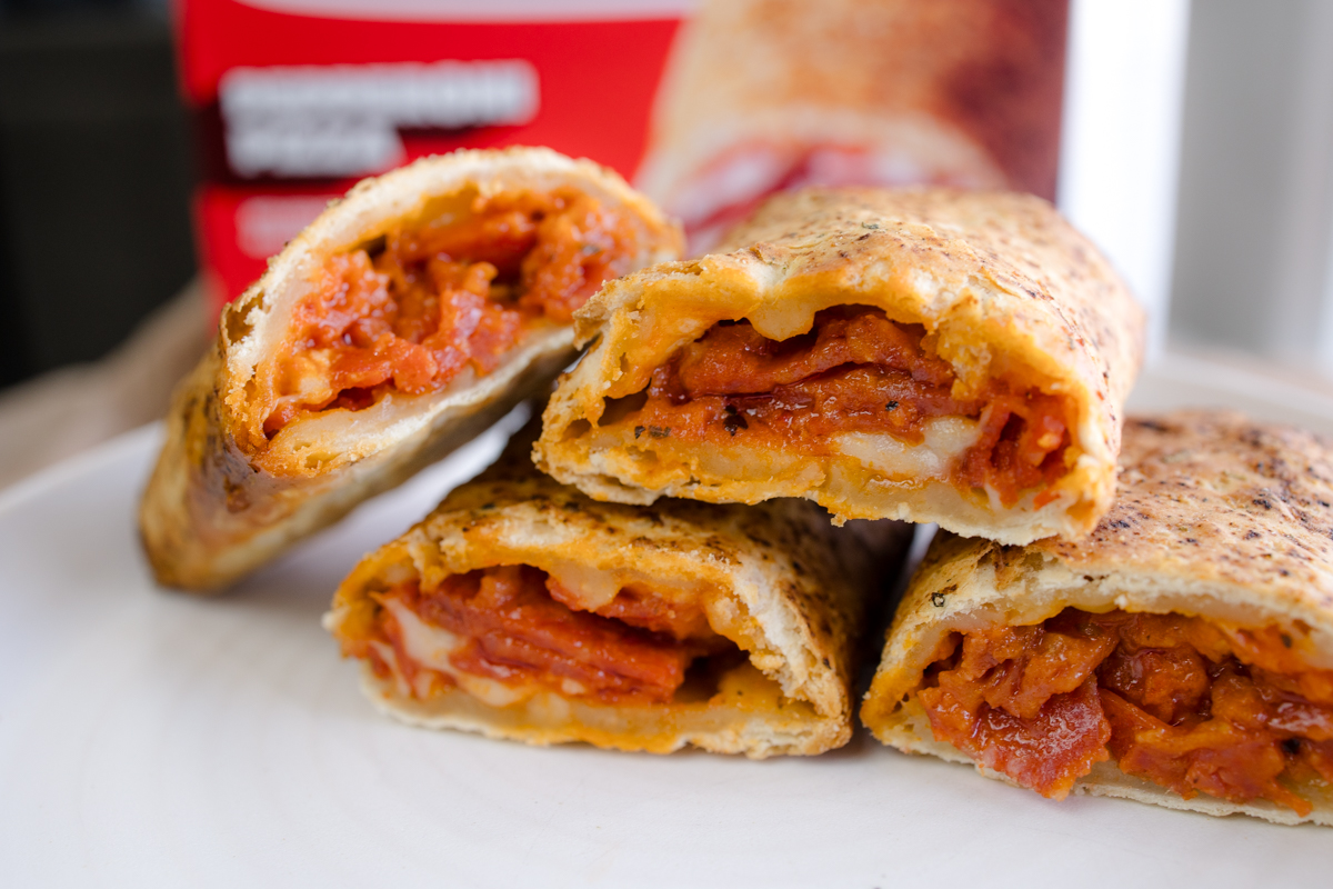Close up view of Hot Pockets sliced in half to reveal the middle.