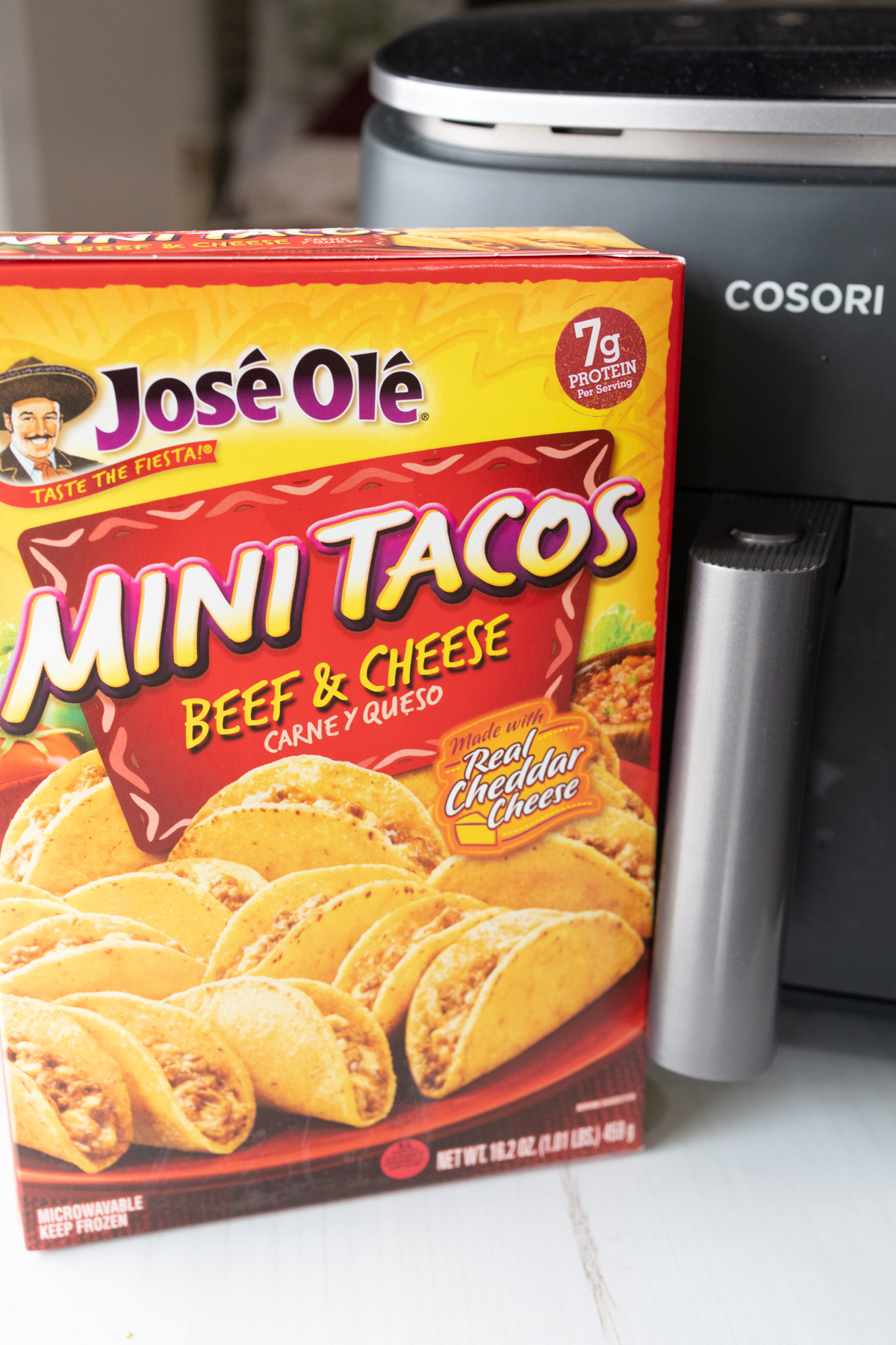 A box of José Olé Mini Tacos in front of an air fryer.