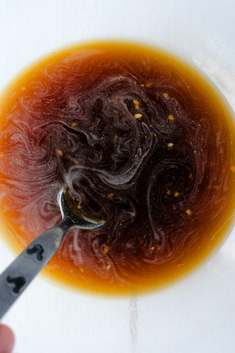 Overhead view of teriyaki sauce in a glass bowl.