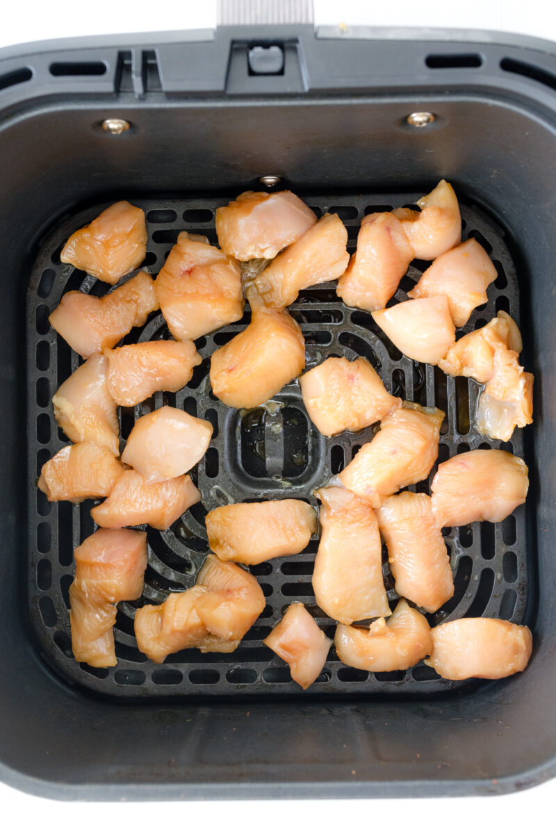 Overhead view of uncooked Air Fryer Chicken Teriyaki in an air fryer basket.