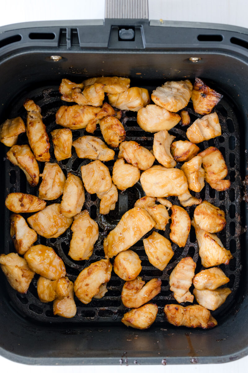 Overhead view of cooked Air Fryer Chicken Teriyaki in an air fryer basket.