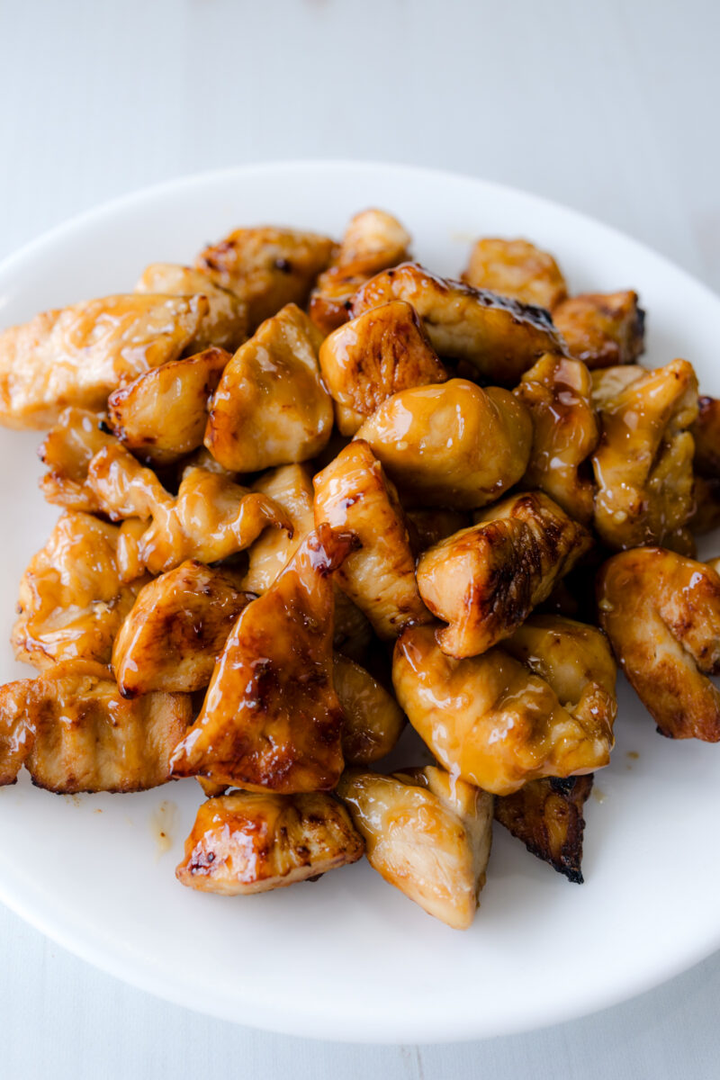 Angled view of Air Fryer Chicken Teriyaki on a white plate.