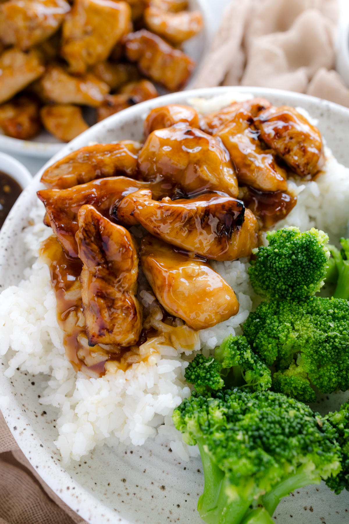 Close up overhead image of Air Fryer Teriyaki Chicken on a white plate with rice and broccoli.