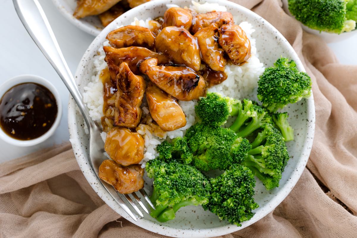 Overhead image of Air Fryer Teriyaki Chicken on a white plate with rice and broccoli.
