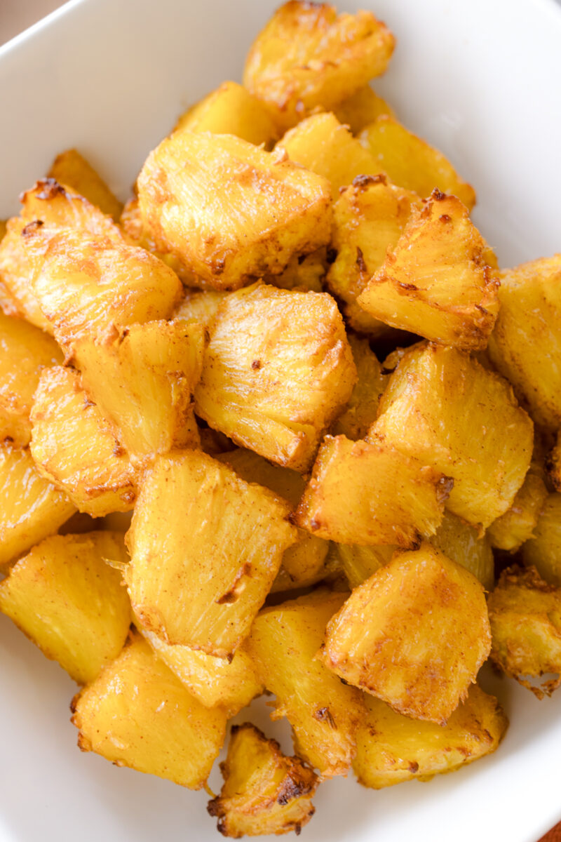 Close up view of Air Fryer Pineapple in a square, white dish.
