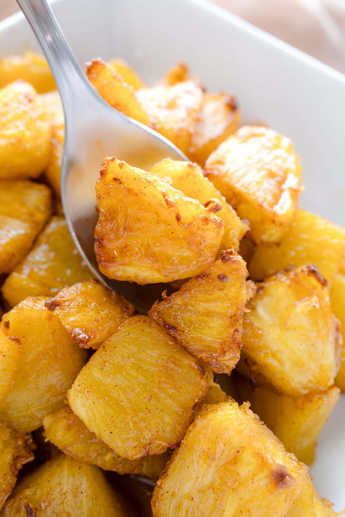 Close up view of Air Fryer Pineapple in a square, white dish.