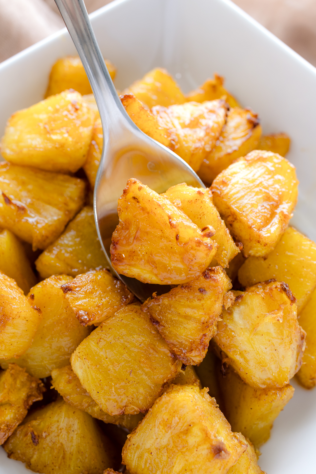 Close up view of Air Fryer Pineapple in a square, white dish.