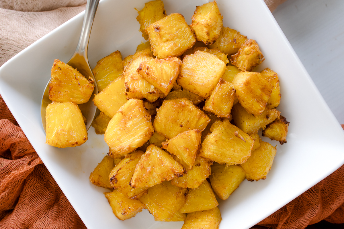 Overhead view of Air Fryer Pineapple in a square, white dish.