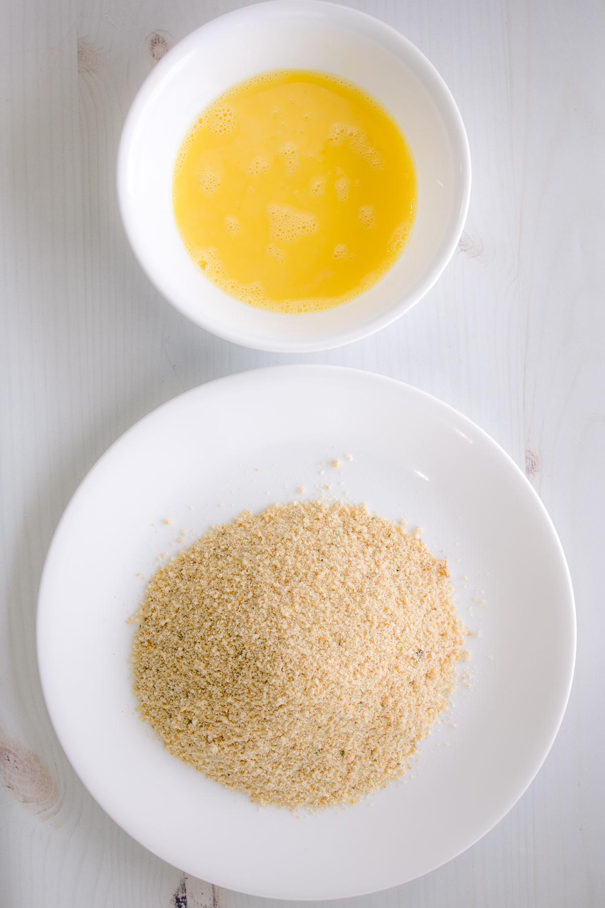 Egg wash and bread crumb mixture prepped for breading pork chops.