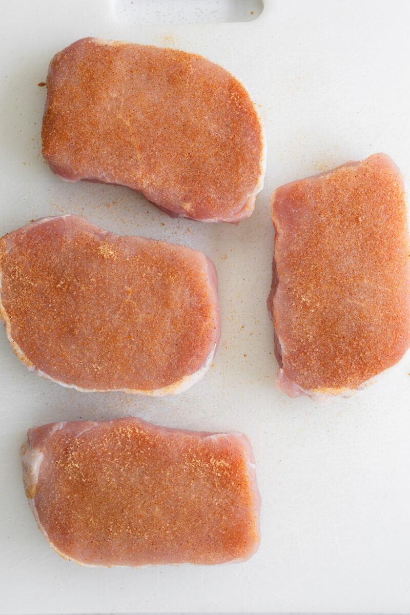 Raw seasoned chops patted dry and laid out.