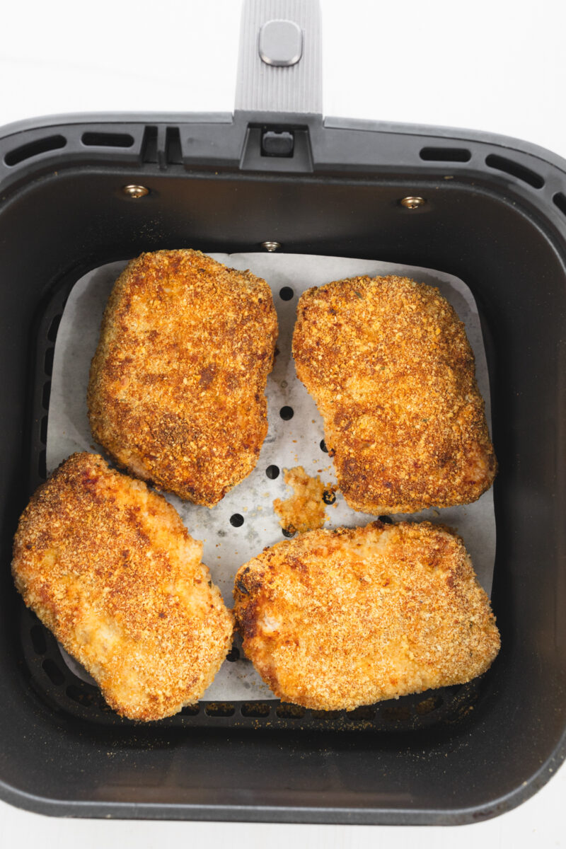 Breaded pork chops cooked to crispy perfection inside the air fryer.